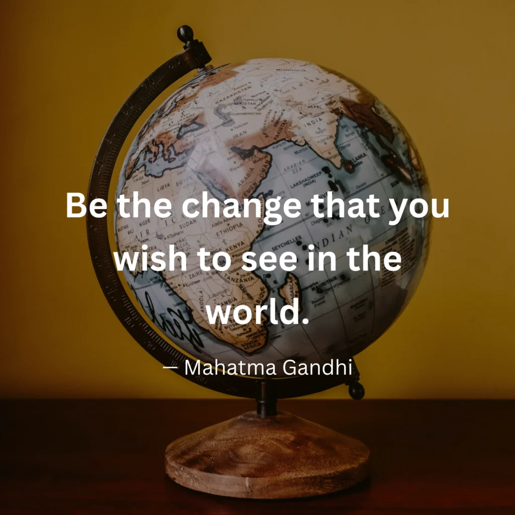 An inspirational graphic featuring a desktop globe against a warm background with text: "Be the change that you wish to see in the world." – Mahatma Gandhi