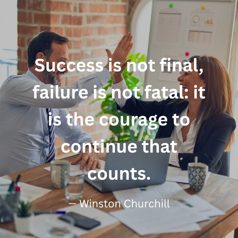 An inspirational graphic featuring two smiling colleagues high-fiving at an office desk with text: "Success is not final, failure is not fatal: it is the courage to continue that counts." – Winston Churchill